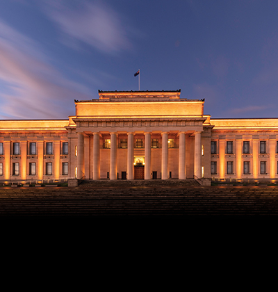The Museum at dusk, lit up in gold